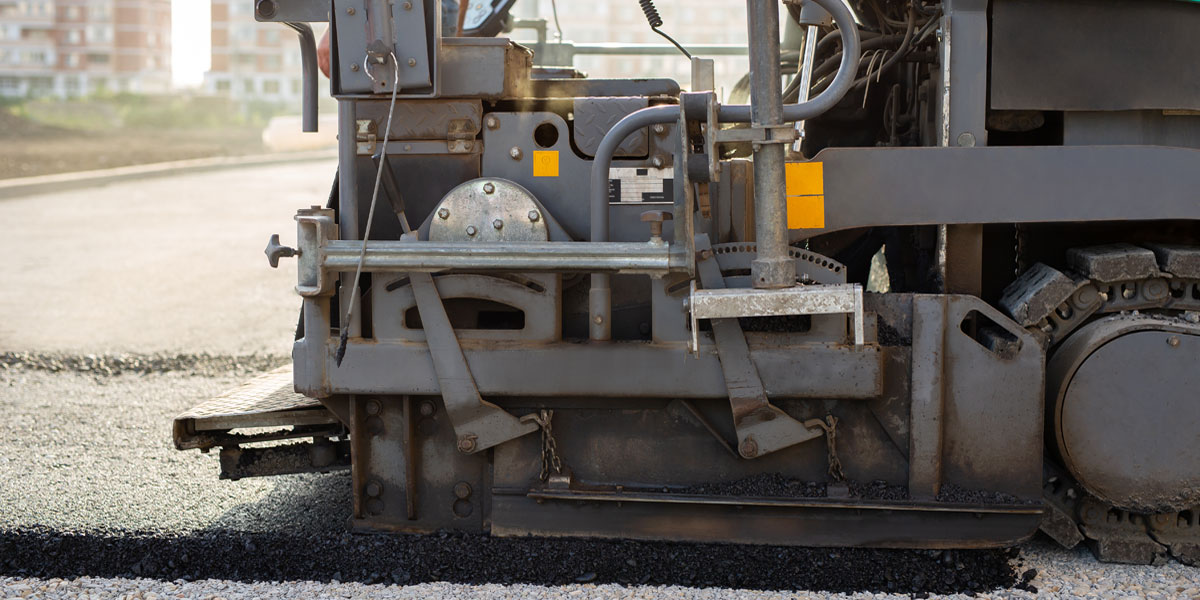 Asphalt being spread on to the gravel to build an asphalt road in Tampa.