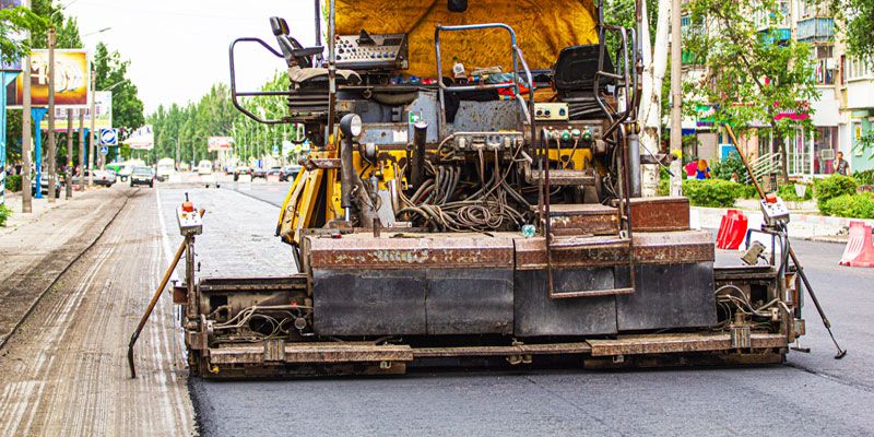 A Road Paver Finisher spreads asphalt in Tampa.